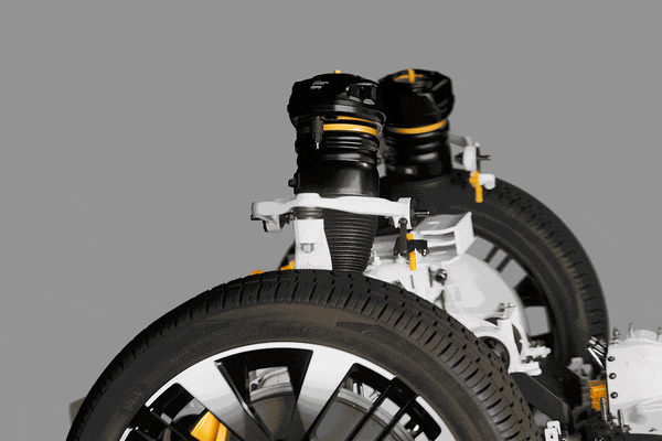 A car suspension system moves above a wheel