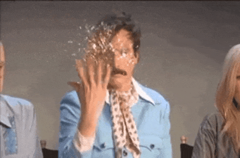 A man in a blue suit gives a slow clap